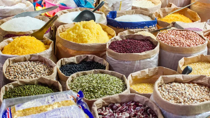Pulse prices under pressure as diverse varieties including lentils, chickpeas, black matpe, green mung beans, and pigeon peas are displayed in open sacks at a wholesale grain market