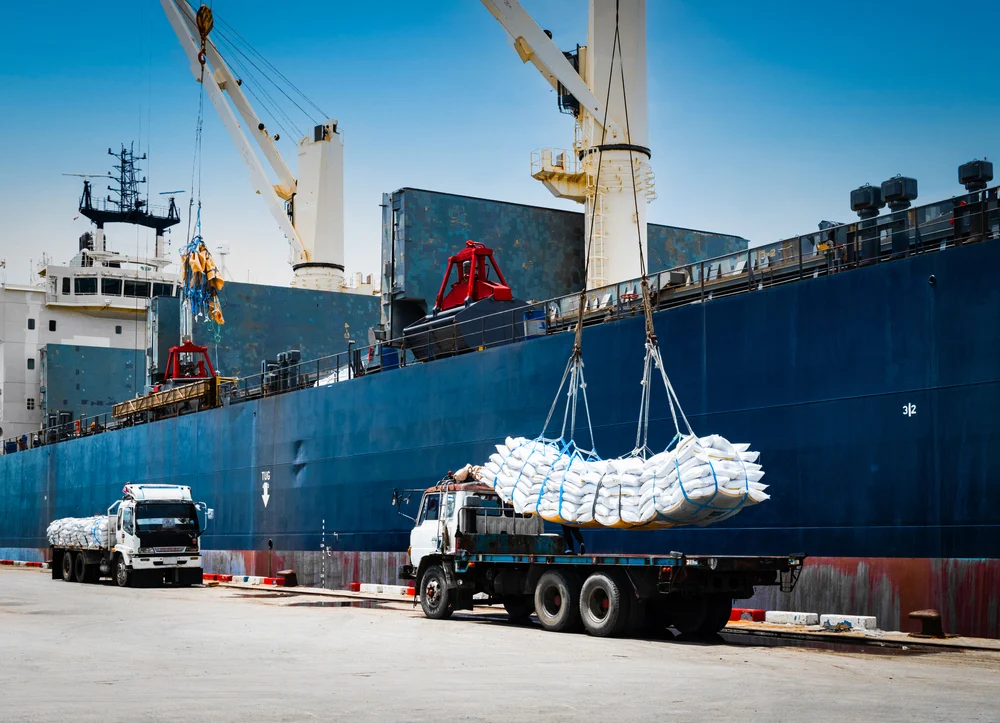 Workers moving rice cargo